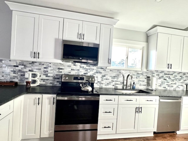 kitchen featuring stainless steel appliances, sink, and white cabinets