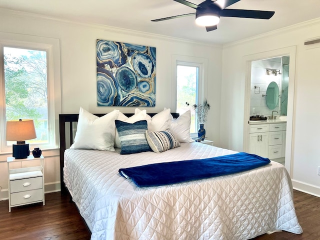 bedroom featuring dark hardwood / wood-style flooring, ensuite bath, ornamental molding, and ceiling fan