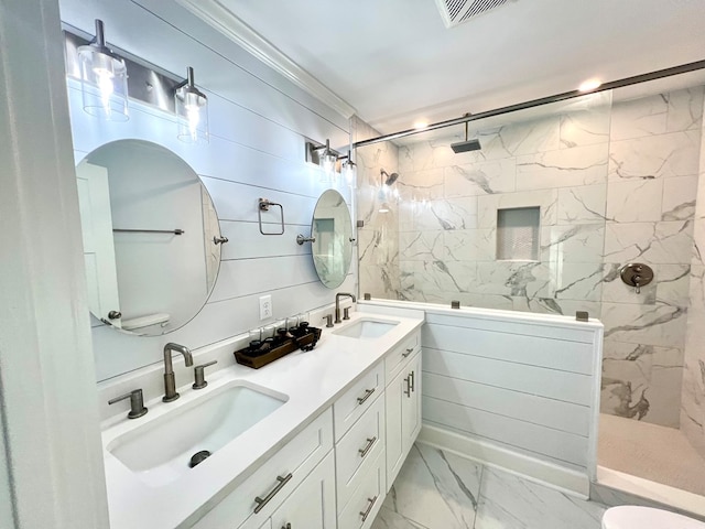 bathroom with tiled shower and vanity