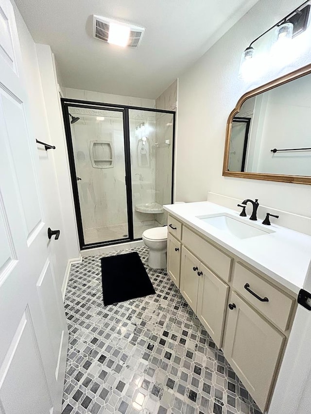 bathroom featuring walk in shower, vanity, and toilet