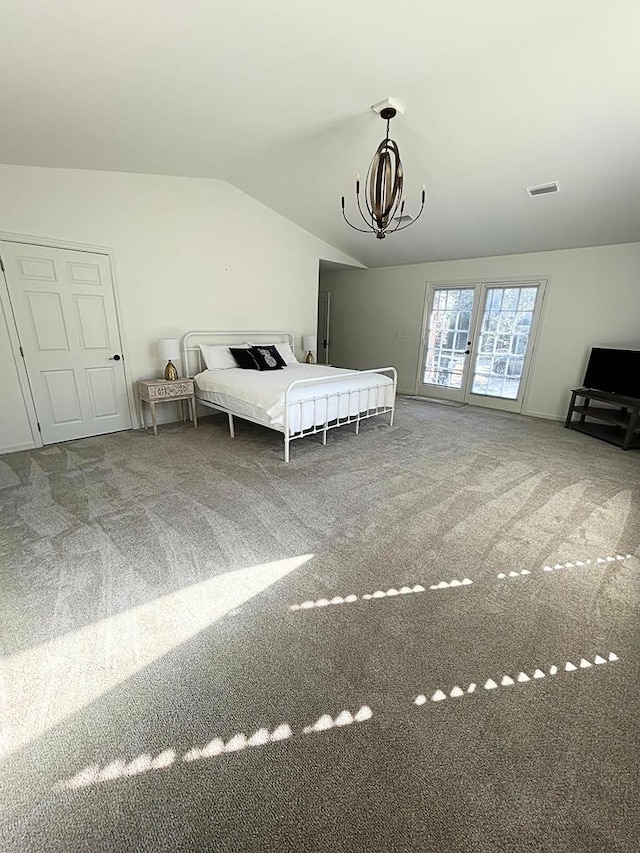 unfurnished bedroom featuring vaulted ceiling, carpet, and a notable chandelier