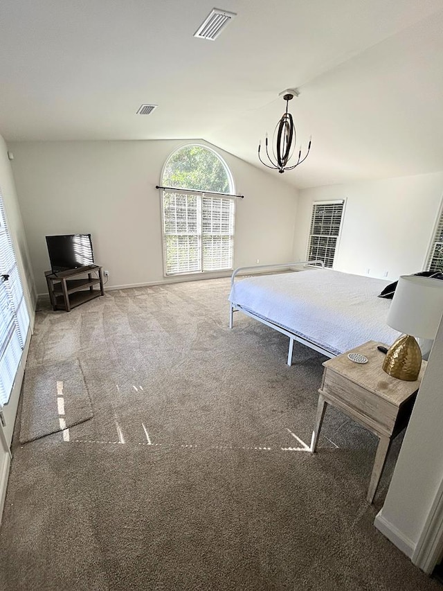 unfurnished bedroom with vaulted ceiling, carpet flooring, and an inviting chandelier