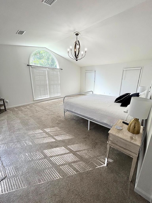 bedroom with lofted ceiling, carpet flooring, and a chandelier