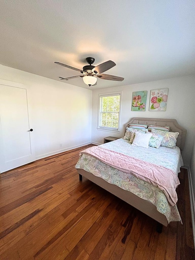 bedroom featuring dark hardwood / wood-style floors and ceiling fan