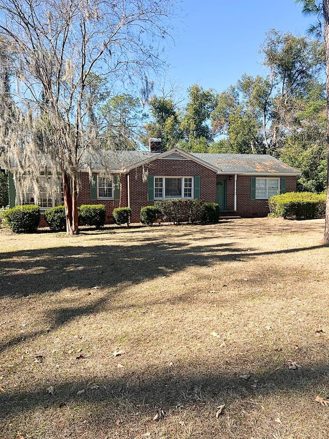 ranch-style house with a front lawn