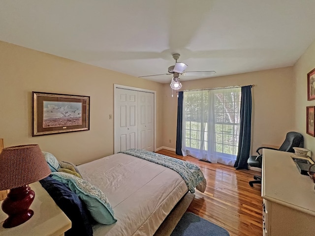 bedroom with ceiling fan, a closet, and light hardwood / wood-style floors