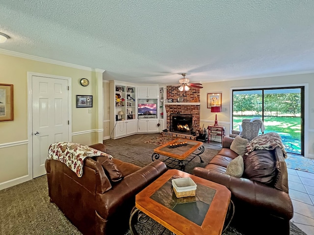 living room featuring a brick fireplace, a textured ceiling, ceiling fan, crown molding, and dark colored carpet