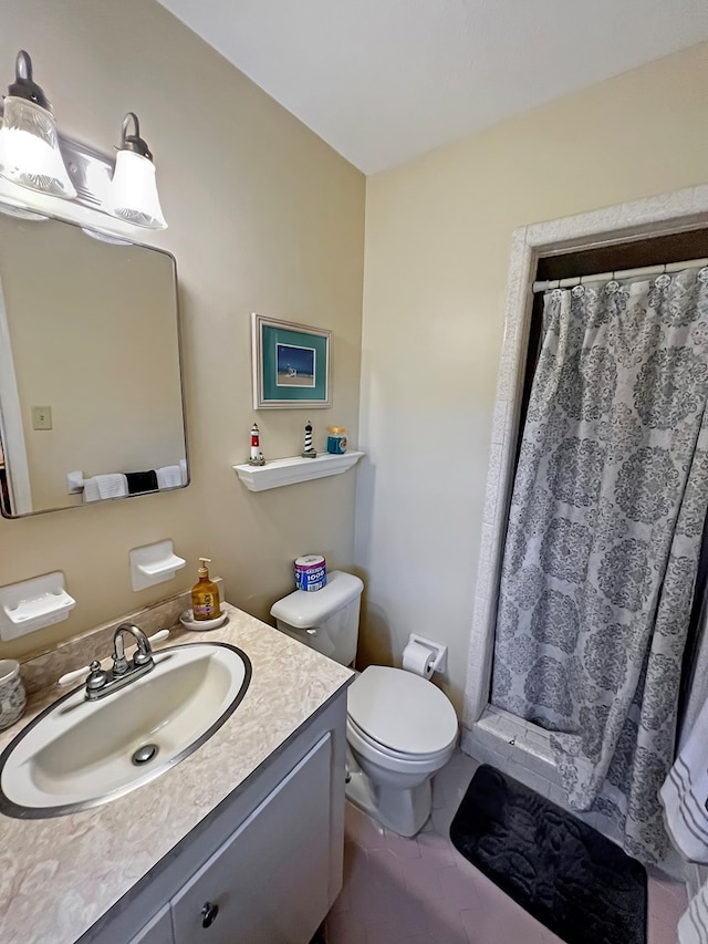 bathroom featuring walk in shower, vanity, and toilet