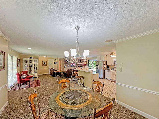 dining room featuring ceiling fan with notable chandelier, light colored carpet, a textured ceiling, and ornamental molding