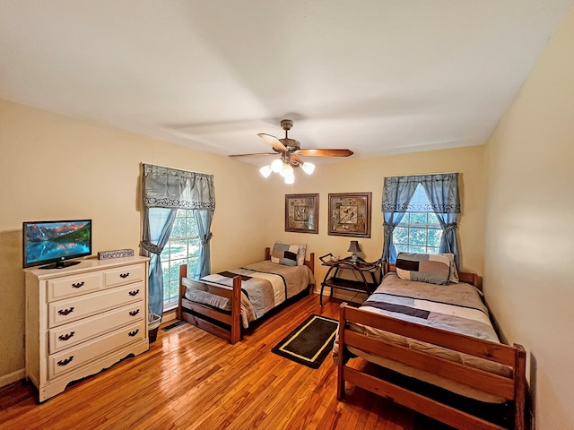 bedroom with ceiling fan and light hardwood / wood-style floors