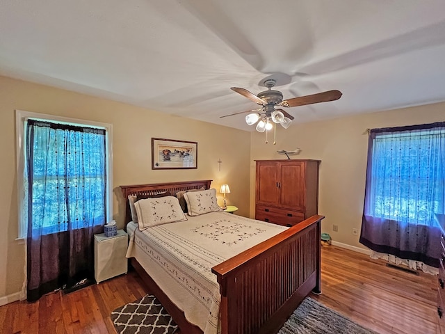 bedroom with ceiling fan and dark hardwood / wood-style flooring