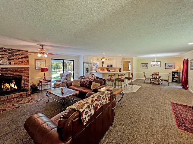 living room featuring carpet flooring, a fireplace, ceiling fan, and a textured ceiling