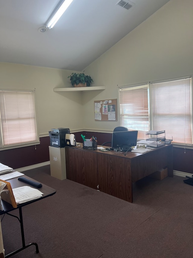 carpeted office with vaulted ceiling and visible vents