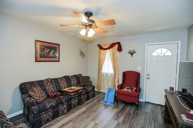 living room featuring ceiling fan, a healthy amount of sunlight, and wood-type flooring