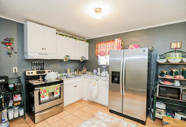 kitchen with light tile patterned floors, stainless steel appliances, white cabinetry, and sink
