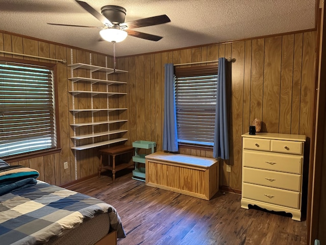 145 Robin Ln, Bainbridge, GA 39819 - bedroom featuring wooden walls, dark wood finished floors, a textured ceiling, crown molding, and ceiling fan