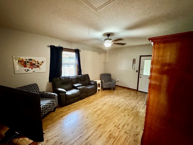 145 Robin Ln, Bainbridge, GA 39819 - living room with a textured ceiling, light wood-style floors, and a ceiling fan