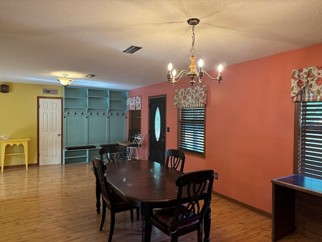 145 Robin Ln, Bainbridge, GA 39819 - dining area featuring a chandelier, wood finished floors, and a textured ceiling