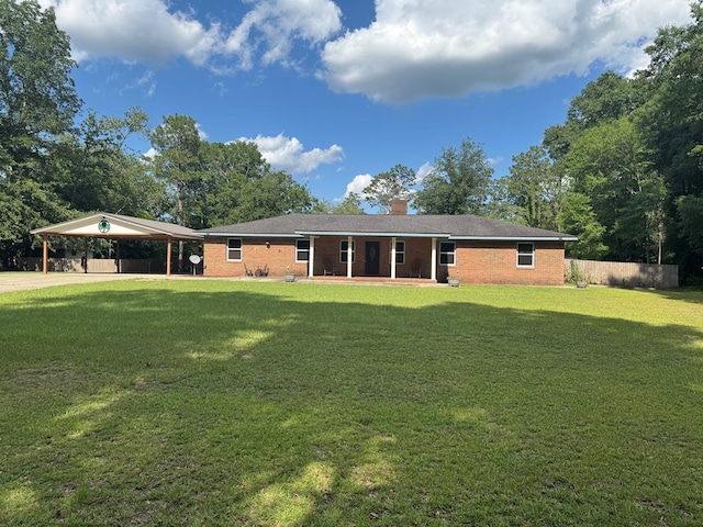 145 Robin Ln, Bainbridge, GA 39819 - rear view of house with an attached carport, driveway, a chimney, and brick siding