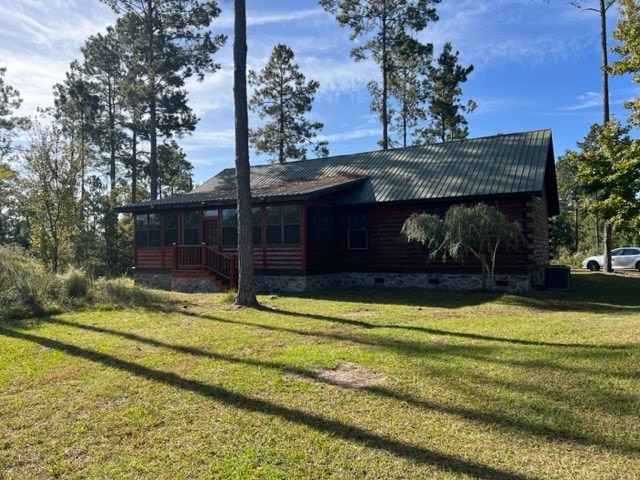 back of property featuring a lawn