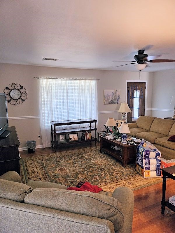 living room with hardwood / wood-style floors, ceiling fan, and a healthy amount of sunlight