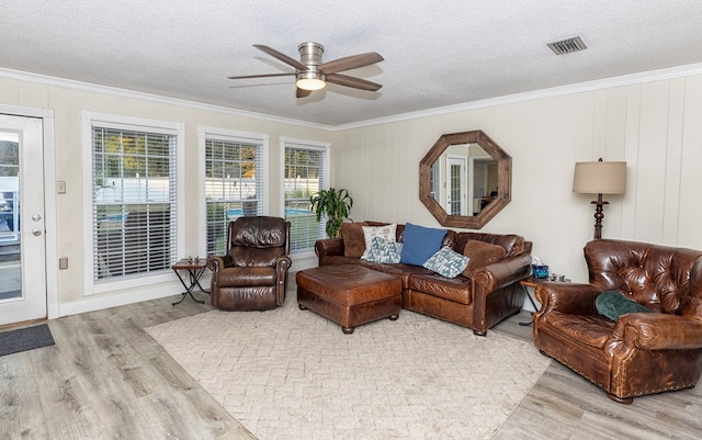 1107 Douglas Dr, Bainbridge, GA 39819 - living area with wood finished floors, ornamental molding, a ceiling fan, healthy amount of natural light, and a textured ceiling