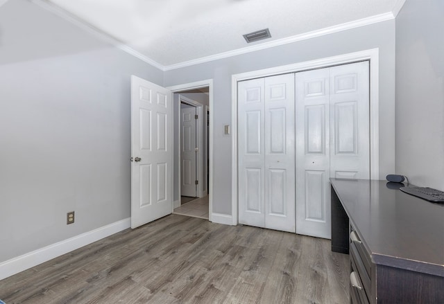 1107 Douglas Dr, Bainbridge, GA 39819 - unfurnished bedroom featuring ornamental molding, wood finished floors, baseboards, and a closet