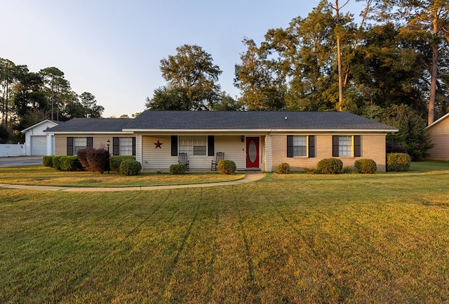 ranch-style home featuring a garage and a front lawn