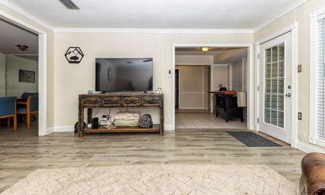1107 Douglas Dr, Bainbridge, GA 39819 - living area featuring ornamental molding, wood finished floors, a textured ceiling, and baseboards