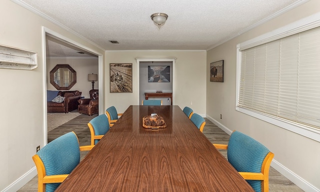 1107 Douglas Dr, Bainbridge, GA 39819 - dining area featuring wood finished floors, baseboards, a textured ceiling, and crown molding