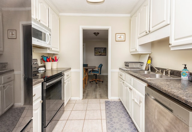 1107 Douglas Dr, Bainbridge, GA 39819 - kitchen featuring stainless steel appliances, a sink, crown molding, light tile patterned flooring, and white cabinets