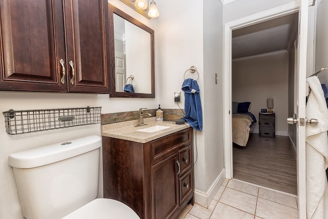 1107 Douglas Dr, Bainbridge, GA 39819 - bathroom with vanity, toilet, tile patterned flooring, ornamental molding, and baseboards