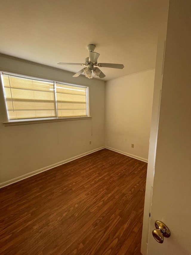 empty room featuring ceiling fan and dark hardwood / wood-style flooring