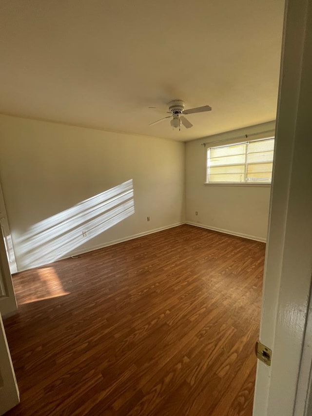 unfurnished room featuring dark hardwood / wood-style floors and ceiling fan