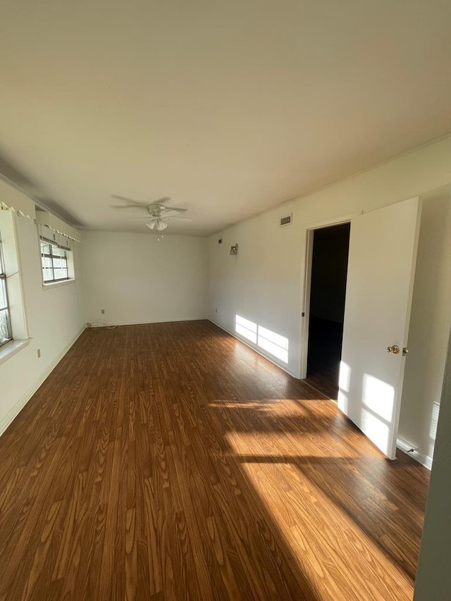 empty room with wood-type flooring and ceiling fan