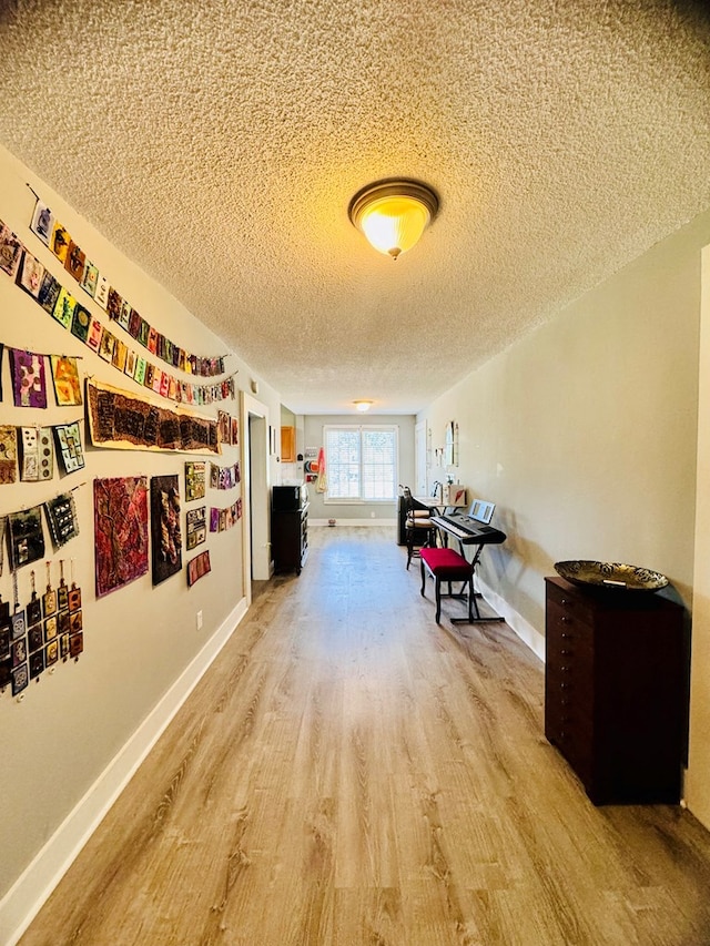 interior space with a textured ceiling and hardwood / wood-style flooring