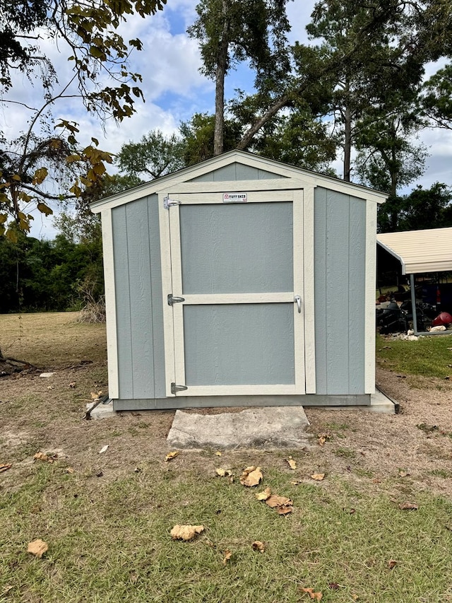 view of outbuilding with a yard