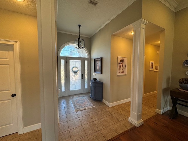 687 River Oaks Dr, Bainbridge, GA 39817 - entrance foyer featuring ornate columns, a textured ceiling, ornamental molding, and light wood finished floors