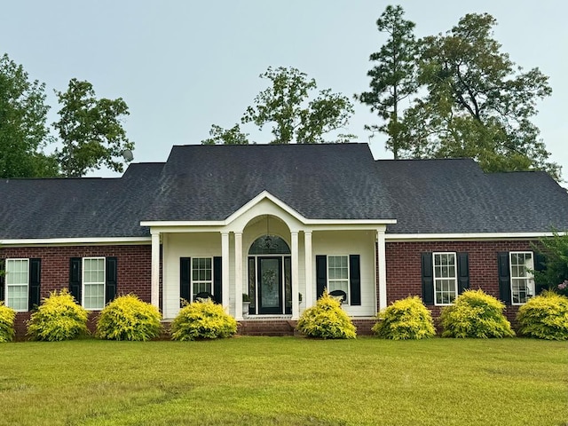 687 River Oaks Dr, Bainbridge, GA 39817 - view of front of home with a front yard, brick siding, and a shingled roof