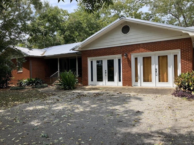 back of property featuring french doors