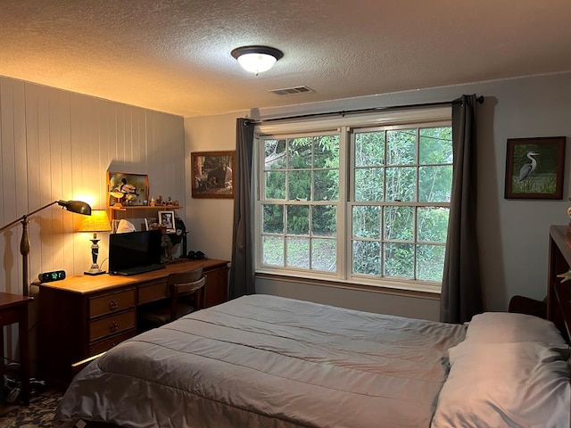 851 Colquitt Hwy, Bainbridge, GA 39817 - bedroom with a textured ceiling and wood walls