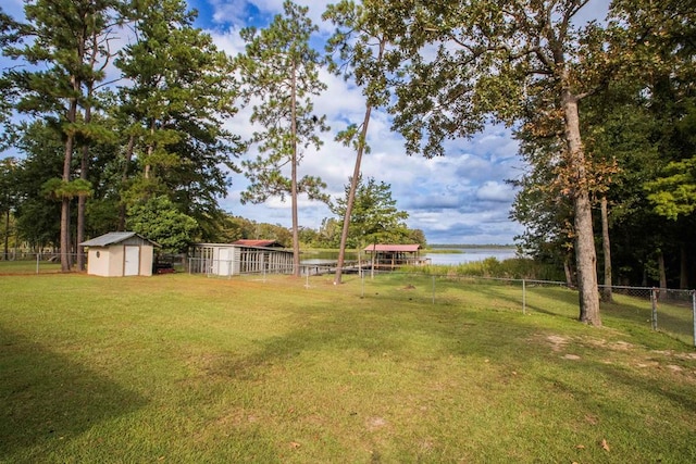 view of yard with a water view and a shed