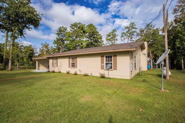 view of side of home with a yard