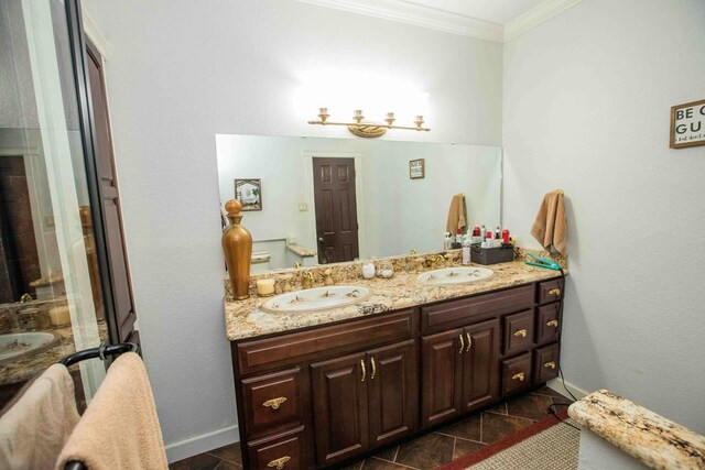 bathroom with tile patterned floors, crown molding, and vanity