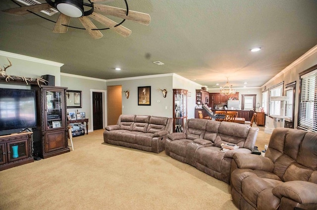 living room featuring ceiling fan with notable chandelier, light colored carpet, and crown molding