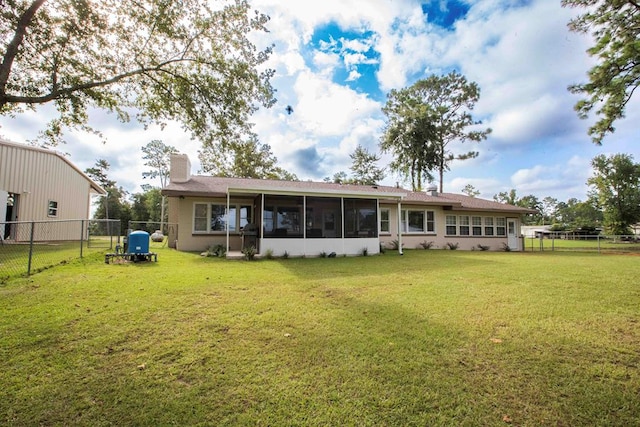 back of house featuring a sunroom and a yard