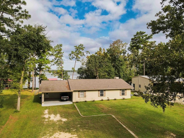 exterior space with a yard and a carport