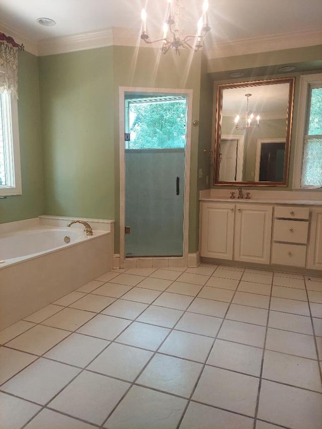 1490 Magnolia Dr, Cairo, GA 39828 - full bath featuring tile patterned flooring, a garden tub, a notable chandelier, and a wealth of natural light