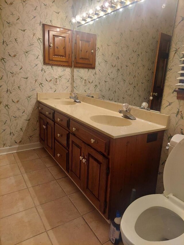 1490 Magnolia Dr, Cairo, GA 39828 - full bathroom featuring double vanity, tile patterned flooring, a sink, baseboards, and toilet