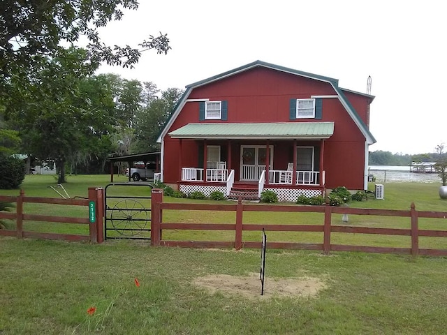 2772 Stapleton Dr, Donalsonville, GA 39845 - colonial inspired home with a porch, a gambrel roof, an attached carport, a water view, and metal roof